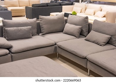 Showroom in the upholstered furniture store department with sofas. An example of a room with pastel shades of color for corner sofas