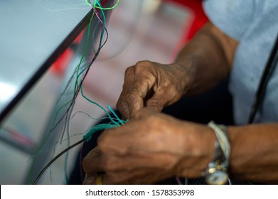 Shows The Hand Of A Basket Weaver