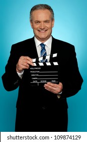 Its Showtime. Businessman Holding Clapperboard