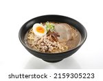 Shoyu- Tonkotsu Ramen (Ramen noodles in pork and shoyu broth soup) in a bowl on white background.

