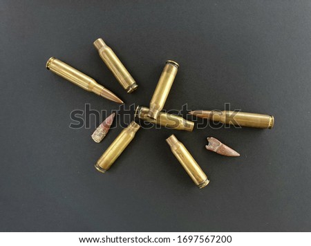 Shrapnel explosion, represented by bullets, cartridges and shells. Background with objects related to hunting, the army, fighting and shooting. Concepts related to hunters, soldiers, war, education.