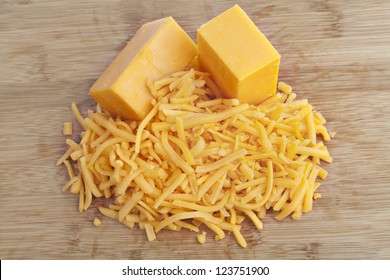 Shredded Cheddar Cheese On A Brown Background
