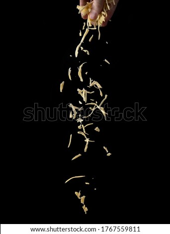 Shredded cheese on a black background