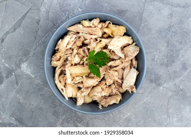 Shredded Chicken Breast In Grey Bowl On Grey Background.