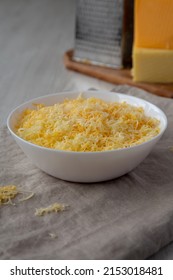 Shredded Mexican Cheese Mix In A White Bowl, Side View. 