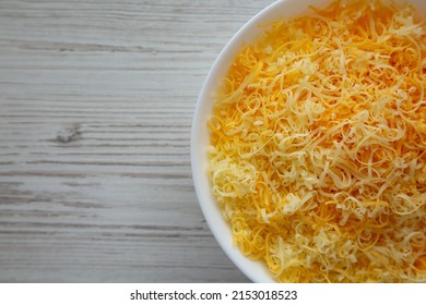 Shredded Mexican Cheese Mix In A White Bowl, Top View. Flat Lay, Overhead, From Above. Space For Text.