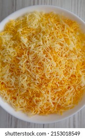 Shredded Mexican Cheese Mix In A White Bowl, Top View. Flat Lay, Overhead, From Above. 