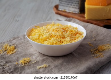 Shredded Mexican Cheese Mix In A White Bowl, Side View. 