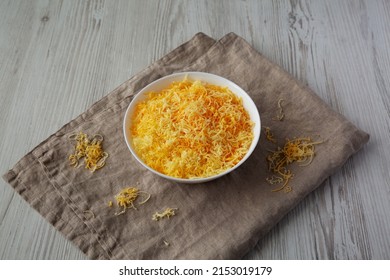 Shredded Mexican Cheese Mix In A White Bowl, Side View.