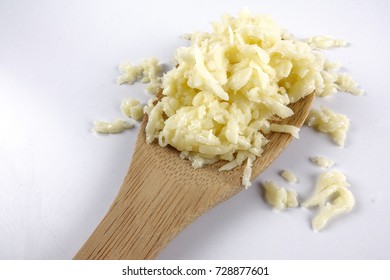 Shredded Mozarella Cheese In The Wooden Spoon Isolated On White.