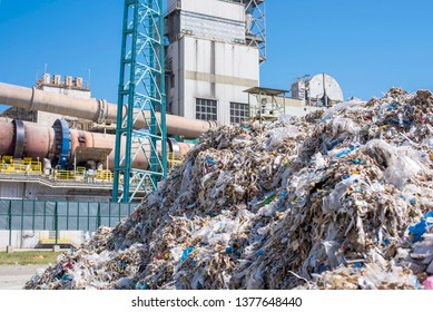 Shredded Municipal Waste Used As Alternative Fuel And Rotary Cement Kiln In The Background