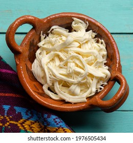 Shredded Oaxaca Cheese Also Called Quesillo On Turquoise Background. Traditional Mexican Food