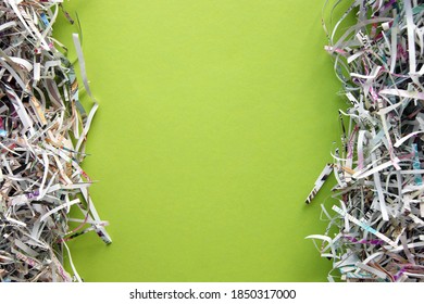 Shredded paper on light green background. Selective focus image.