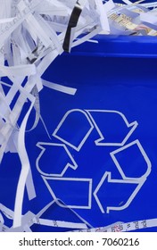 Shredded Paper Spilling Out Of Blue Recycle Bin