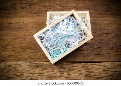 Shredded Paper In Wooden Box On Wooden Board