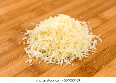 Shredded parmesan cheese on a wood background