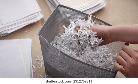 Shredded private confidential documents. Shredded paper in a shredder container