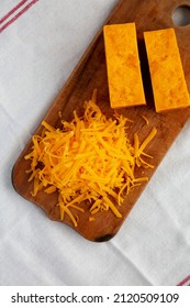 Shredded Sharp Cheddar Cheese On A Rustic Wooden Board, Top View. Flat Lay, Overhead, From Above.