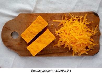 Shredded Sharp Cheddar Cheese On A Rustic Wooden Board, Top View. Flat Lay, Overhead, From Above.