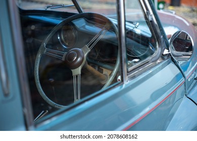 Shrewsbury, England, UK - 09.12.2021: Looking through the front window of a Morris Minor car. The steering wheel is shown.