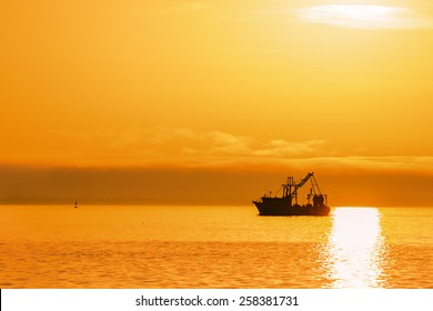 Shrimp Boat On Ocean At Sunset On Gulf Of Mexico