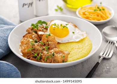 Shrimp And Cheesy Grits Topped With Egg Served For Breakfast