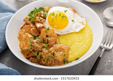 Shrimp And Cheesy Grits Topped With Egg Served For Breakfast