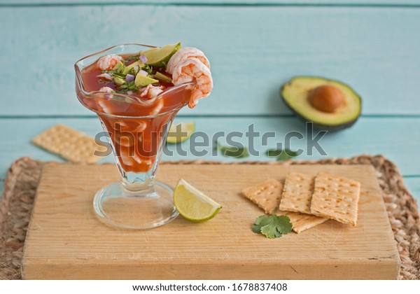 Shrimp cocktail with avocado, cilantro, lime and\
red onions.