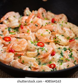 Shrimp In A Creamy Garlic Sauce With Parsley And Lime In A Frying Pan