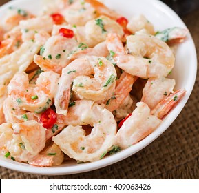 Shrimp In A Creamy Garlic Sauce With Parsley And Lime In White Bowl