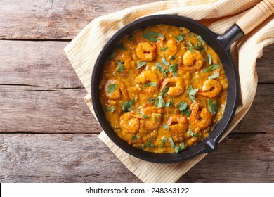 Shrimp In Curry Sauce In The Pan. Horizontal View From Above 