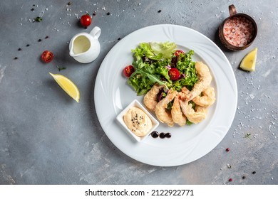 Shrimp fried in batter and sauce with salad. Healthy food, keto diet, diet lunch concept.
