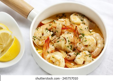 Shrimp With Garlic Butter, Lemon And Chives, In White Serving Pan.