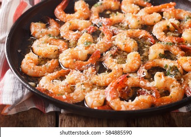 Shrimp With Garlic, Parmesan And Herbs Closeup On A Frying Pan. Horizontal
