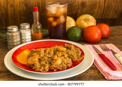 Shrimp Gumbo Dinner In Rustic Outdoor Setting With Iced Tea And Louisiana Hot Sauce On Old Wood Tabletop.