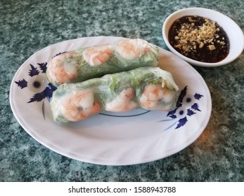 Shrimp And Lettuce Wrap With Peanut Sauce On Table