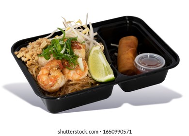 Shrimp Pad Thai with Fried Spring Roll and Sweet Sauce in Takeaway Box on White Background. Asian Food. Delivery Food. Clipping Path on the main object (not the shadow) Included.