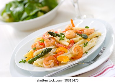 Shrimp Penne (tube-shaped Pasta) With Asparagus, Bell Pepper, Origan And Creamy Alfredo Sauce . Green Salad. Shallow DOF