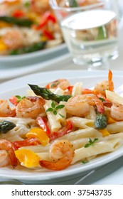 Shrimp Penne (tube-shaped Pasta) With Asparagus, Bell Pepper, Origan And Creamy Alfredo Sauce . Green Salad. Shallow DOF