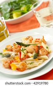 Shrimp Penne (tube-shaped Pasta) With Asparagus, Bell Pepper, Origan And Creamy Alfredo Sauce . Green Salad. Shallow DOF