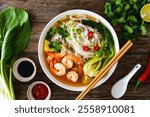 Shrimp Pho soup - Vietnamese soup with shrimps on wooden table