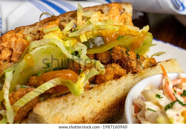 Shrimp Po\'Boy\
sandwich with friend shrimp, sliced green tomatoes, lettuce,\
remoulade sauce served on French\
bread