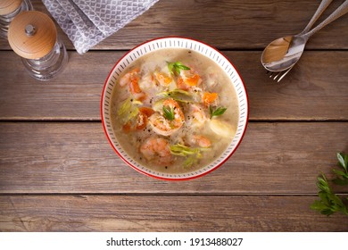 Shrimp Prawn Chowder With Crab Meat In A Bowl On Wooden Table. Overhead Horizontal Photo