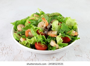 Shrimp salad with avocado, cherry tomatoes, green leaf mix salad and sesame seeds on a white background.  - Powered by Shutterstock