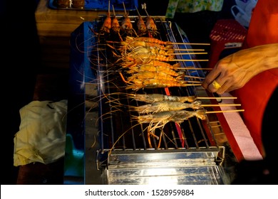 shrimp skewers to grilled dish that is roasted on the stove, it is delicious and beneficial to the body, popular for sale in the market or seafood restaurant - Shutterstock ID 1528959884