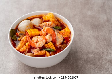 Shrimp soup bowl, Tom yum or tom yam is a type of hot and sour Thai soup, usually cooked with shrimp (prawn). Tom yum has its origin in Thailand.