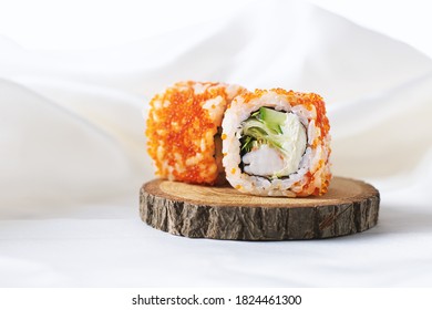 Shrimp sushi rolls. Two sushi rolls with shrimp on wooden plate. Philadelphia, California sushi