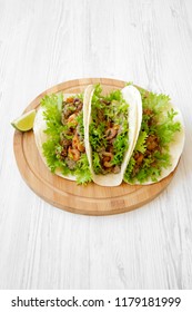 Shrimp Tacos On Round Bamboo Board On White Wooden Background, High Angle View. Mexican Cuisine.