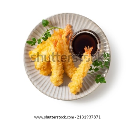 Shrimp tempura on a plate placed on a white background. Tempura is a Japanese food. It is Japanese fried shrimp. View from above