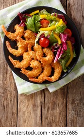 Shrimp Tempura And Salad Of Fresh Vegetables Close-up On A Plate On A Table. Vertical View From Above
